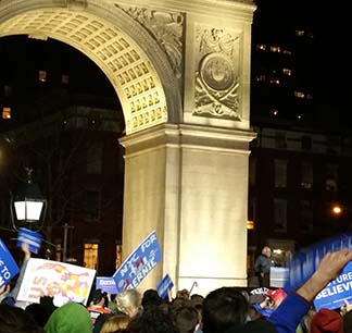 Bernie at podium, arch, mass of people