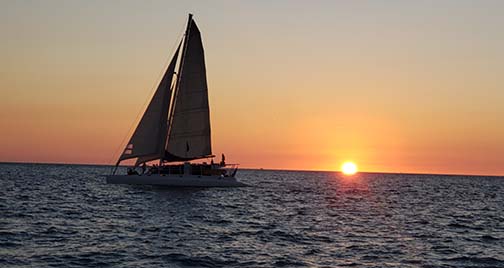 Sailboat-passing-setting-sun